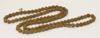Lot 352 - A string of Chinese nut kernels beads