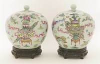 Lot 66 - A pair of Chinese famille rose vases and covers