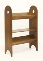 Lot 58 - An Arts and Crafts oak three-tier book rack