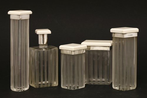 Lot 246 - Four Art Deco ivory-topped and silver-collared dressing table pots