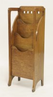 Lot 281 - An Arts and Crafts oak three-division magazine stand