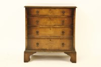 Lot 750 - A reproduction walnut chest of four drawers