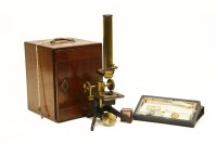 Lot 386 - A cased brass microscope and slides
