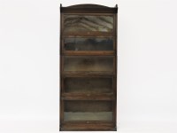 Lot 716 - An early 20th century Lebus oak five section bookcase on outswept plinth base