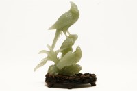 Lot 513 - A Chinese green jade bird group on wooden stand