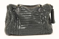 Lot 1076 - An Anya Hindmarch 'Sydney' plaited navy leather woven barrel handbag