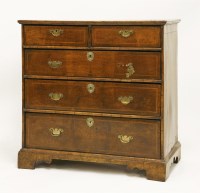 Lot 454 - A walnut chest of two short and three long drawers