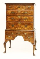 Lot 456 - A walnut and feather banded chest on stand