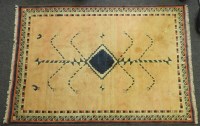 Lot 526 - A Turkish handmade wool rug with geometric motifs on a peach ground