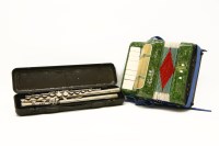 Lot 284 - A children's accordion together with a flute