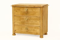 Lot 543 - A stripped pine chest of three drawers