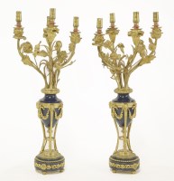 Lot 390 - A pair of French gilt metal and blue royal candelabra