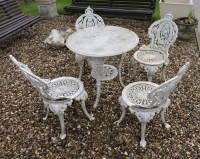 Lot 666 - A set of four cast iron garden chairs