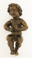 Lot 86 - A carved wood figure of a putto