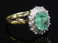 Lot 279 - An emerald and diamond oval cluster ring