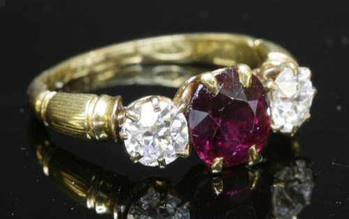 Lot 84 - An 18ct gold Edwardian three stone ruby and diamond ring