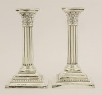 Lot 507 - A pair of George V silver columnar candlesticks