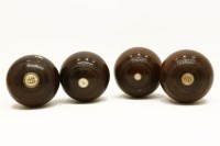 Lot 364 - A set of four lignum vitae bowling balls with inset ivory