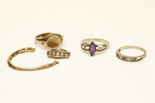 Lot 64 - A gold single stone amethyst ring with pierced shoulders (tested as 9ct gold)
