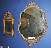 Lot 502 - A small gilt and ebonised wall mirror