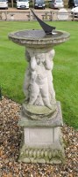 Lot 670 - A concrete and lead sun dial on figural column and stand