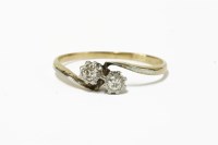 Lot 7 - A gold two stone diamond crossover ring