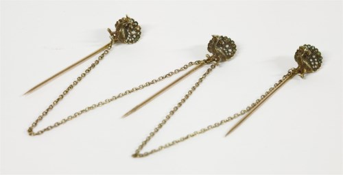 Lot 24 - Three assorted gold Jersey stick pins of peacocks