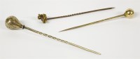 Lot 24 - Three gold stick pins comprising a ball finial example
