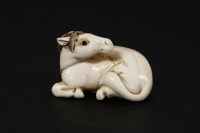 Lot 166 - A Japanese ivory netsuke of a horse lying down