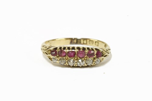 Lot 13 - An 18ct gold two row diamond and ruby six stone ring