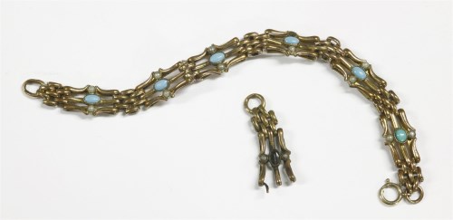 Lot 64 - A rolled gold three row gate bracelet