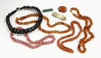 Lot 67 - Two single row graduated faceted amber bead necklace