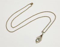 Lot 42 - An Art Deco gold aquamarine drop pendant on belcher chain