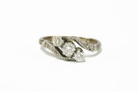 Lot 6 - A three stone diamond crossover ring with diamond set shoulders