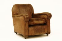 Lot 529 - A 1920s French club armchair upholstered in distressed brown leather