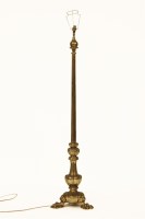 Lot 515 - A gilt metal standard lamp with fitted column on paw feet