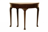 Lot 661 - A George II style mahogany fold-over tea table