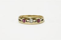 Lot 41 - A gold three stone diamond and ruby pierced ring