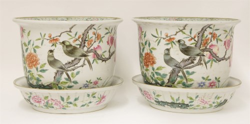 Lot 107 - A pair of famille rose planters and stands