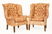 Lot 696 - A pair of Georgian style button backed wing armchairs