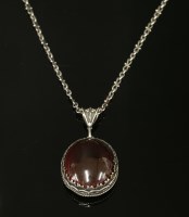 Lot 120 - A silver Arts and Crafts garnet pendant