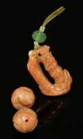 Lot 128 - A Chinese carved coral pendant