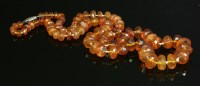 Lot 129 - A single row graduated amber bead necklace
