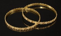 Lot 243 - A pair of high carat gold flat section slave bangles
