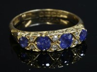 Lot 78 - An 18ct gold Edwardian four stone sapphire and diamond carved head ring