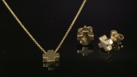 Lot 326 - A gold Tiffany & Co. cube cross pendant and earrings suite