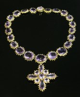 Lot 24 - An early Victorian gold amethyst rivière and brooch pendant drop