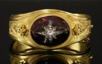 Lot 31 - A Victorian gold garnet and diamond hinged bangle