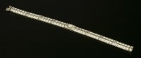 Lot 384 - A two-row diamond set line bracelet