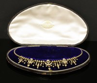 Lot 101 - A cased Edwardian gold and split pearl fringe necklace